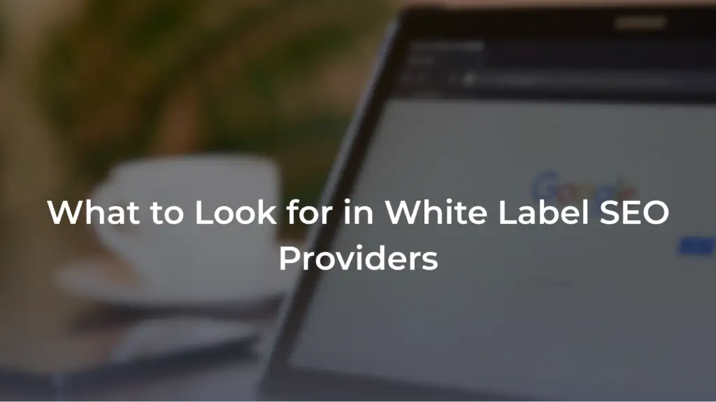 A promotional banner featuring a blurred background of a tablet screen showing the Google homepage, with a coffee cup in the distance. Overlaid in bold white text is the headline: "What to Look for in White Label SEO Providers". 