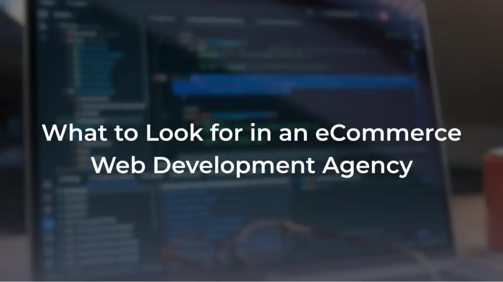 A promotional banner with a blurred background showing lines of code on a laptop screen and a pair of glasses in the foreground. Overlaid in bold white text is the headline: "What to Look for in an eCommerce Web Development Agency".