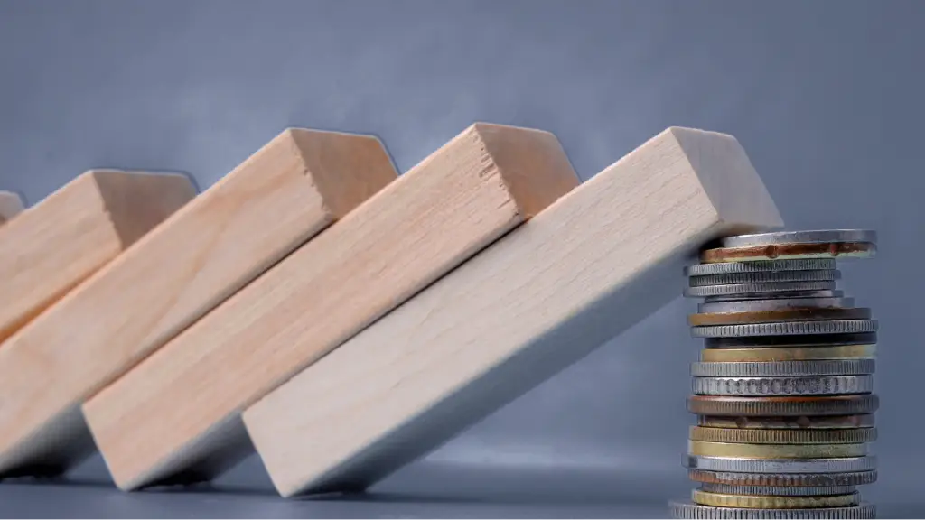 Achieving High-Yield Acquisition Scalability A row of wooden blocks falling toward a stack of coins acting as support, symbolizing acquisition scalability, financial stability, risk management, and sustainable business growth.