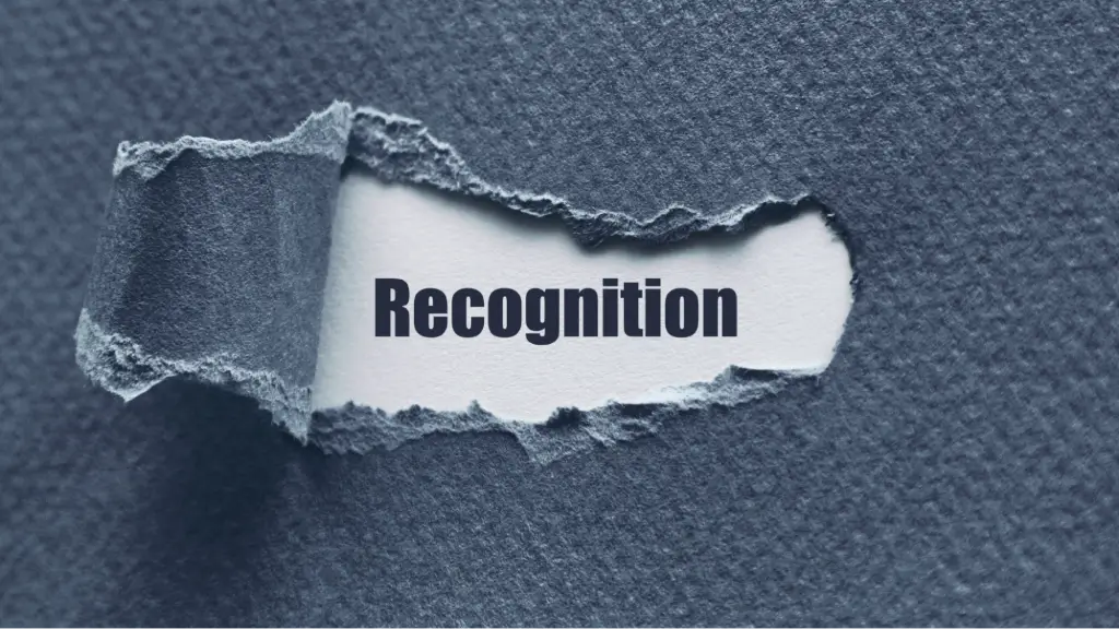 The word “Recognition” appears beneath torn paper, representing brand recognition, entity identification, and improved semantic understanding in AI-powered search.