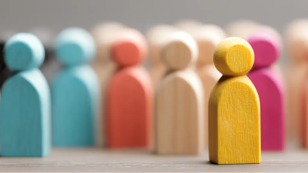 Maximizing Catalog Conversion Through Technical Structural Enhancements A group of colorful wooden human-shaped figures arranged together, with a yellow figure prominently displayed in the foreground. The image symbolizes diversity, teamwork, community, leadership, and inclusion, while the softly blurred background figures create depth and visual focus.