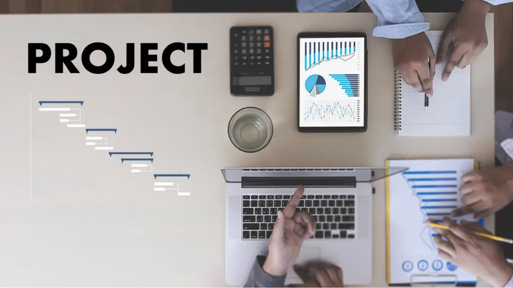 Removing Technical Barriers and Project Delays A project planning workspace with a laptop, tablet displaying analytics, documents, and team members collaborating, representing project management, technical problem-solving, workflow optimization, and the removal of project delays.