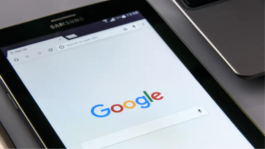 A tablet displays the Google search homepage, representing AI-powered search, Google AI Overviews, and the evolution of intelligent search experiences.