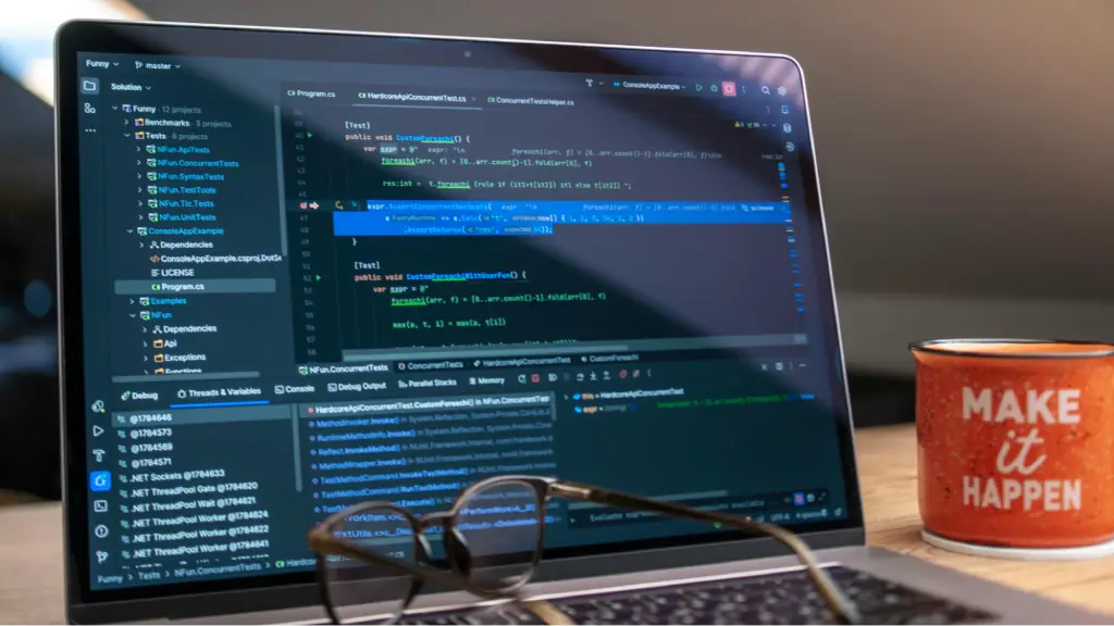 A laptop displaying programming code in a development environment, with eyeglasses and a coffee mug nearby, representing web development, software engineering, coding, debugging, and application building.