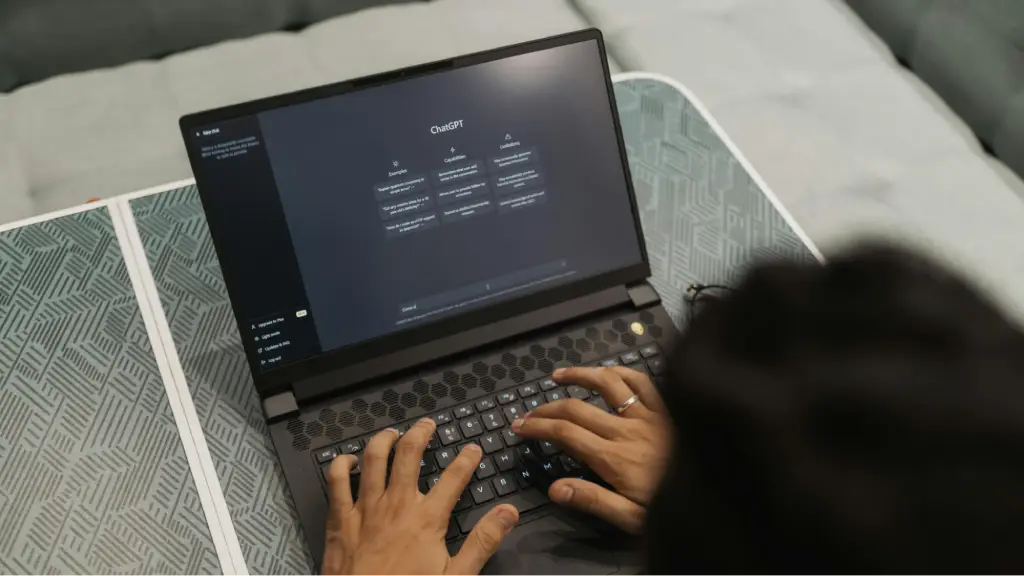 A person uses ChatGPT on a laptop, highlighting the growing importance of generative AI, AI-assisted search, and content optimization for modern digital experiences.
