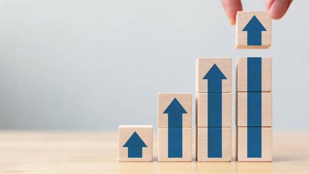 The Revenue Benefits of Reselling PPC Wooden blocks with upward arrows are stacked in increasing height, symbolizing revenue growth, business scalability, and the financial benefits of reselling PPC services.