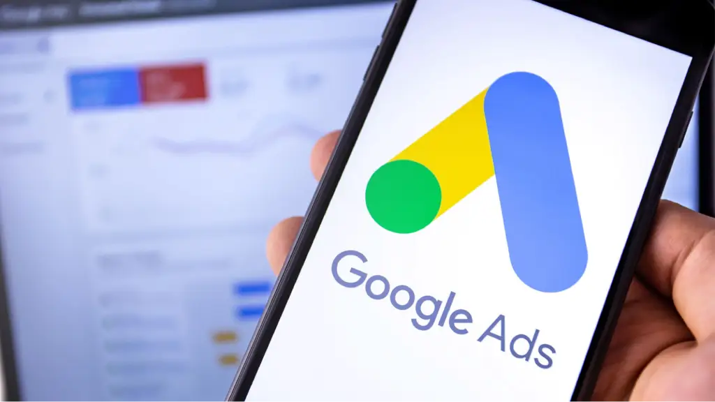 What Is Google Shopping Ads Management_ A smartphone displaying the Google Ads logo represents Google Shopping Ads management for creating, optimizing, and managing ecommerce advertising campaigns.